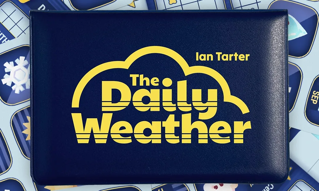 The Daily Weather's navy wallet with its yellow cloud logo and Ian Tarter's name, lying on a spread of the game's weather, weekday and week cards